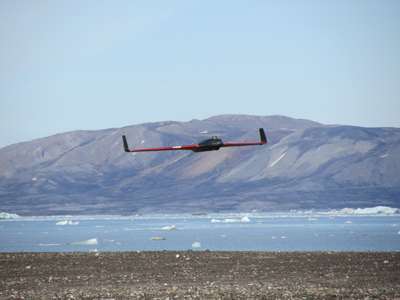 Figure 1. Drone flying in Ny-Ålesund, Svalbard (courtesy the Northern Research Institute, Norut) NTNU Figure 1