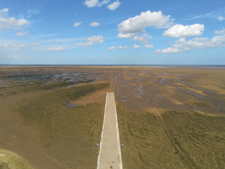 Figure 1. Aerial view of the ramp that leads from the Ørsted construction site and onto the North Cotes intertidal flat Umag Figure 1